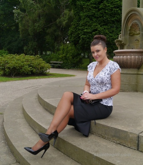 Clothed woman Karen displays her new stiletto heels at a park 85160191