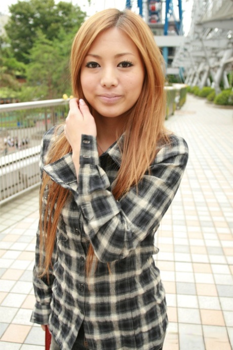 Japanese redhead Anna Morisaki sucks on a drink while clothed in a miniskirt 81560063