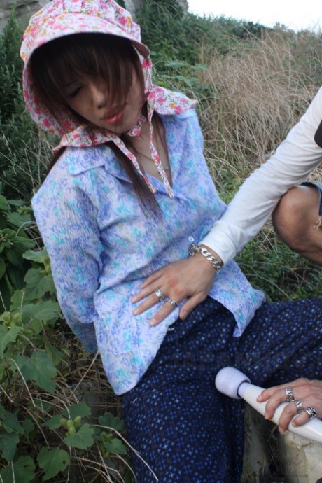 Japanese girl is masturbated thru her pants in rubber boots and a bonnet 83092161