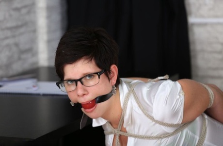 Caucasian secretary with short hair is tied up on a desk chair and gagged too 11432618
