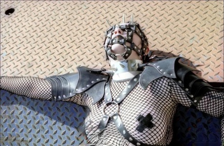 Goth girl is left alone with her hands tied above her head in fetish apparel 21839387