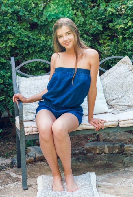 Nice teen Kay J gets naked on a garden bench before touching her bald pussy 34575783