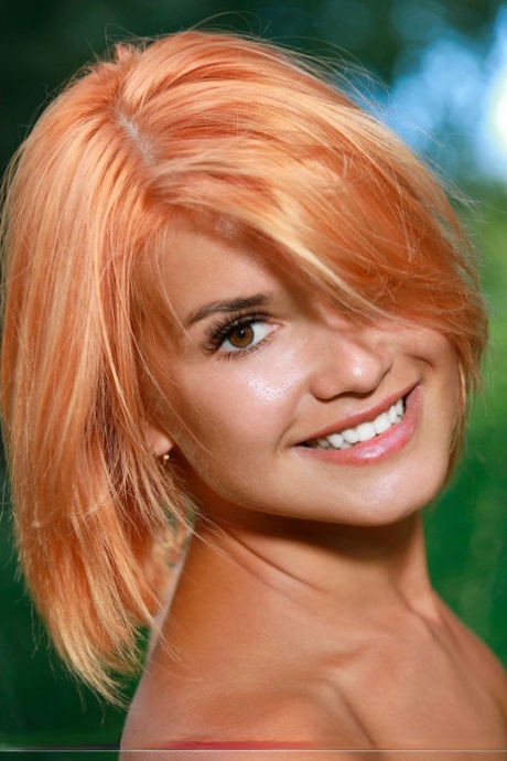 Beautiful redhead Dina P poses for a nude solo shoot in long grass near trees 57266871