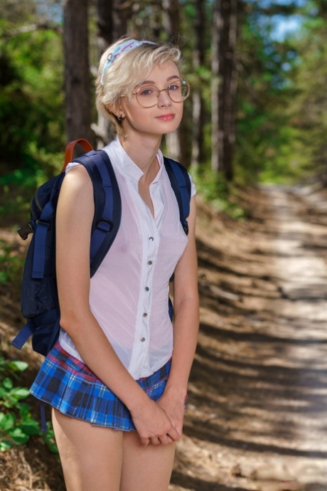 Young looking girl Azshara strips off school clothes on a dirt road in woods 29855440