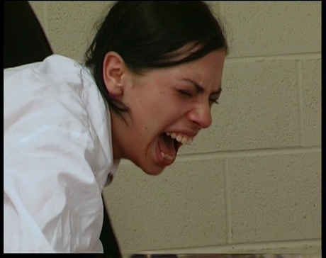 Dark haired student receives a brutal caning over top of her desk 23010870