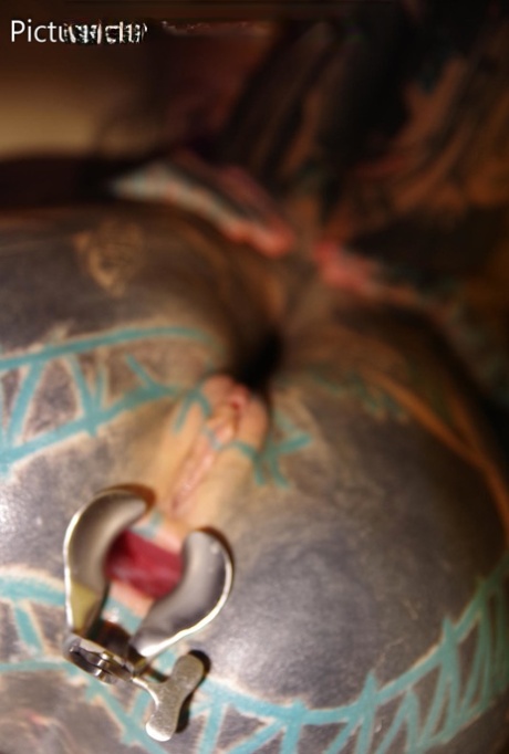 Heavily tattooed girl has her asshole stretched open while somewhat restrained 99832586