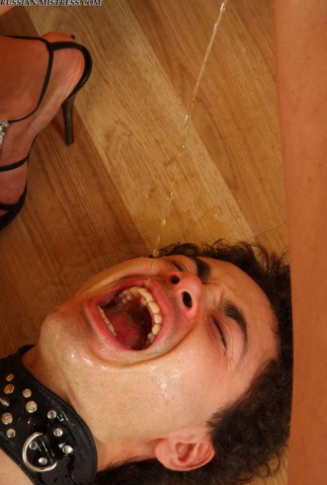 Blonde Russian woman pees into the wide open mouth of her male slave 62901504