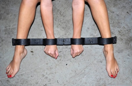 White girl sports a ball gag while attached to a couple of spreader bars 77887818