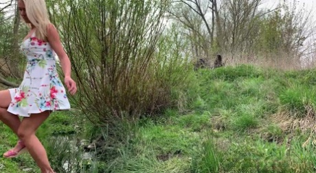 Blonde girl Claudia Macc takes an urgent piss near a stream 10775179