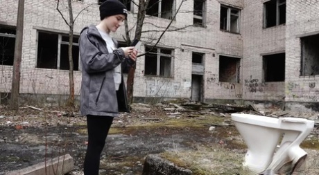 Short taken girl Alexa pisses atop a toilet outside of an abandoned building 44044901