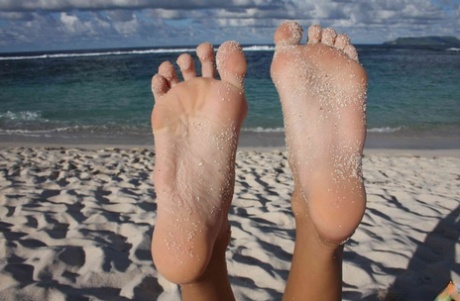 Long legged girl shows the soles of her feet after snorkeling while topless 84051979