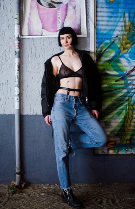 Dark-haired chick Delfine Dahlia takes off her coat while sporting a sheer bra 12712428