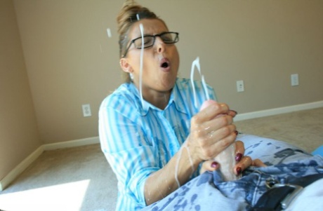 Clothed woman Stacie Starr catches cum in her mouth while jerking a cock 15145244