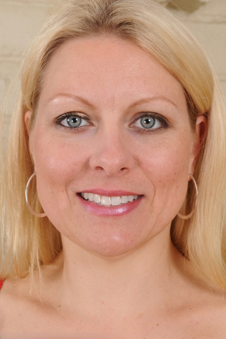 Middle-aged blonde woman Zoey Tyler poses in stockings by the fireplace 74651096