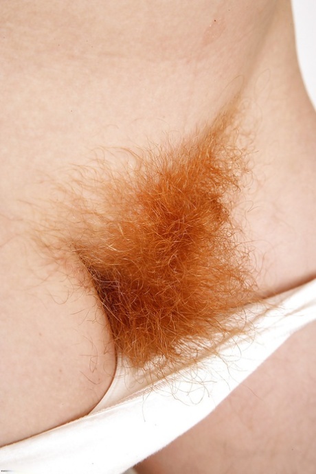 Redhead cutie undressing and exposing her shaggy twat in close up 26943754
